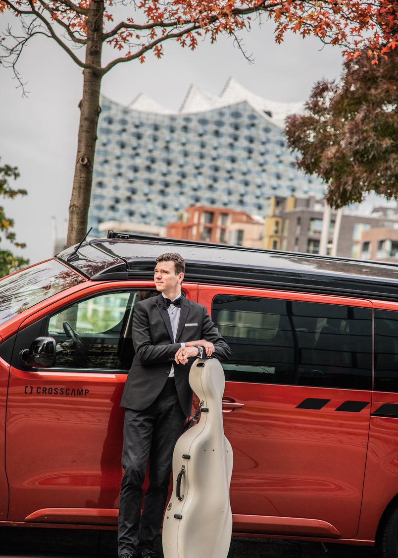 Johannes Raab vor dem CROSSCAMP mit seinem Cello